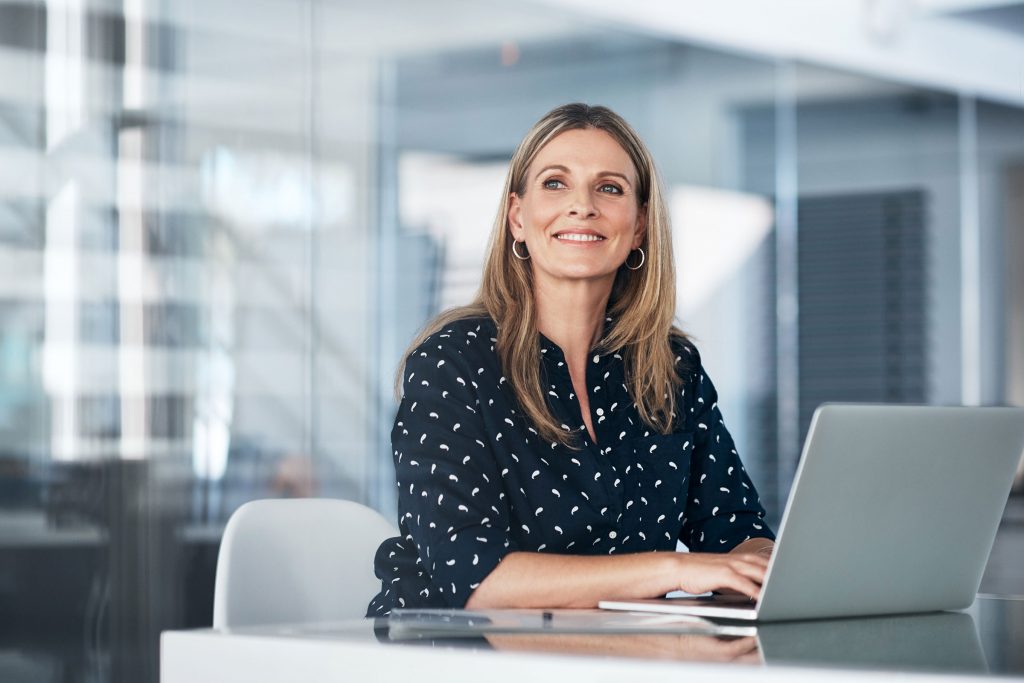 Woman at a computer smiling