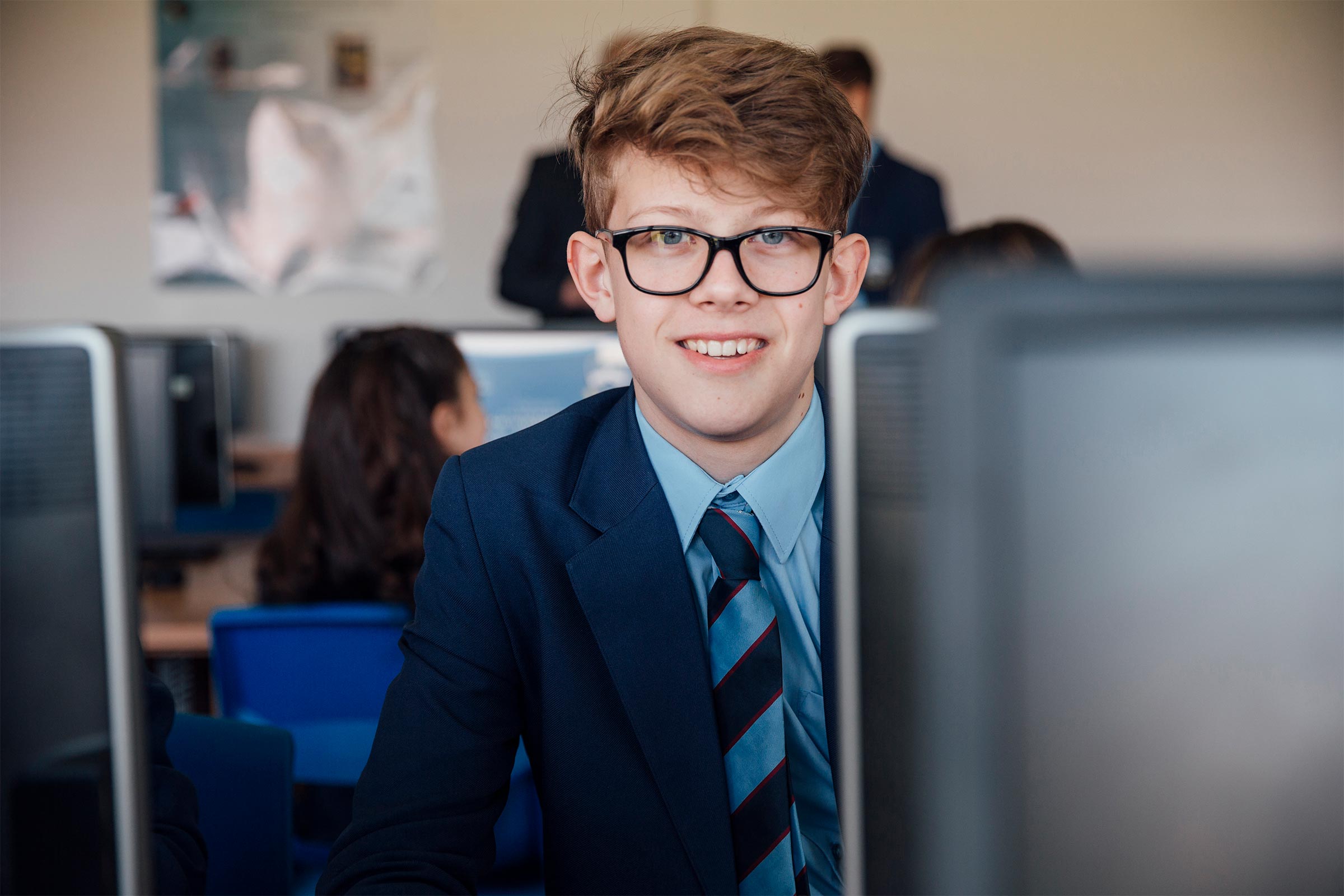 Teenage male looking at a computer full of university speak