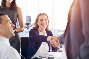 Woman shaking applicants hand at successfully getting a job