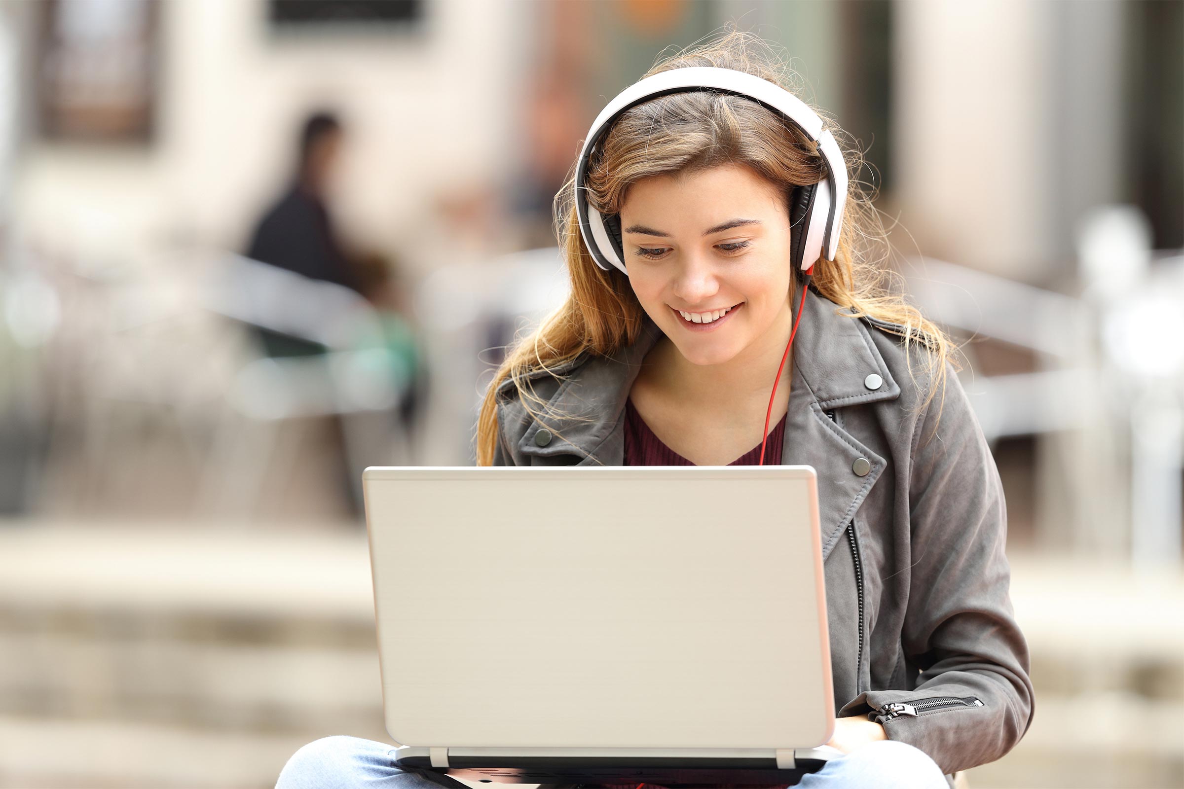 Teenage girl looking at laptop