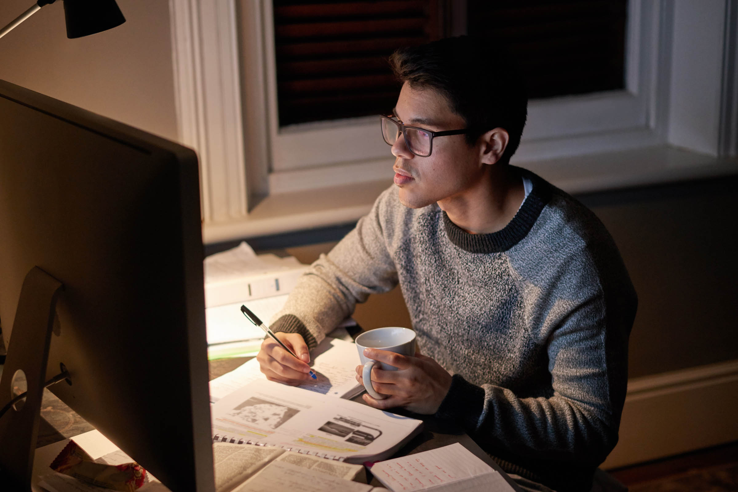 Man at a computer representing how to stay motivated studying online