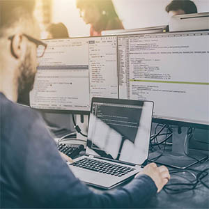 Man at a computer screen demonstrating the technology will be key in the future of policing