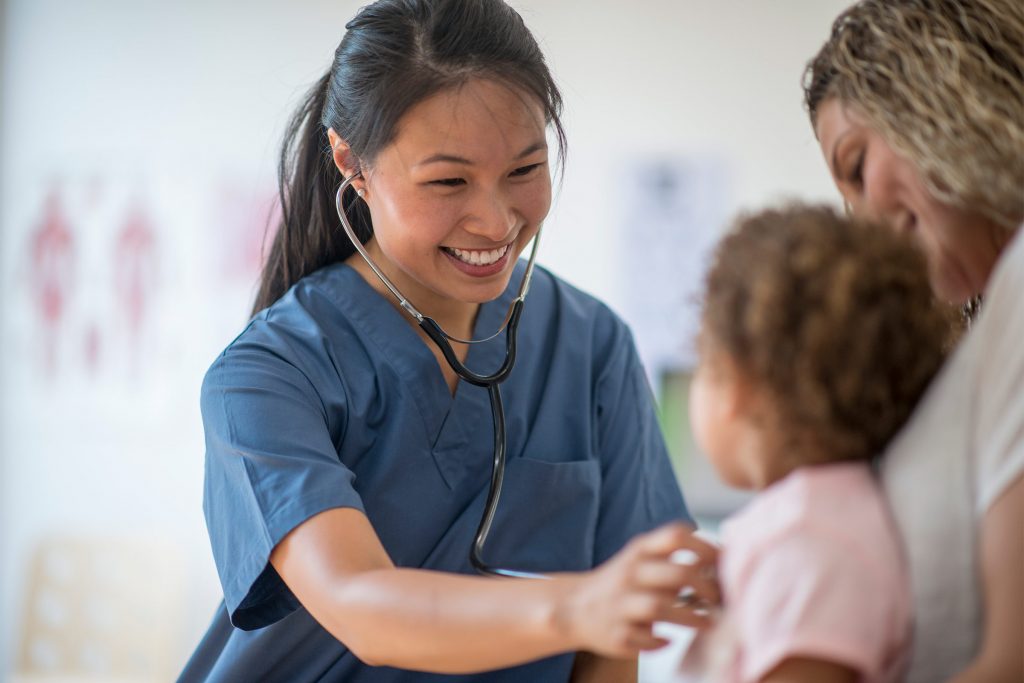 Dosctor using stethoscope on child