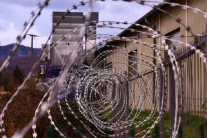Razor wire in front of a prison building