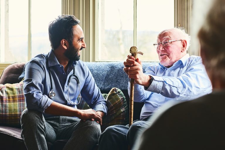 Male doctor talking to an elderly man