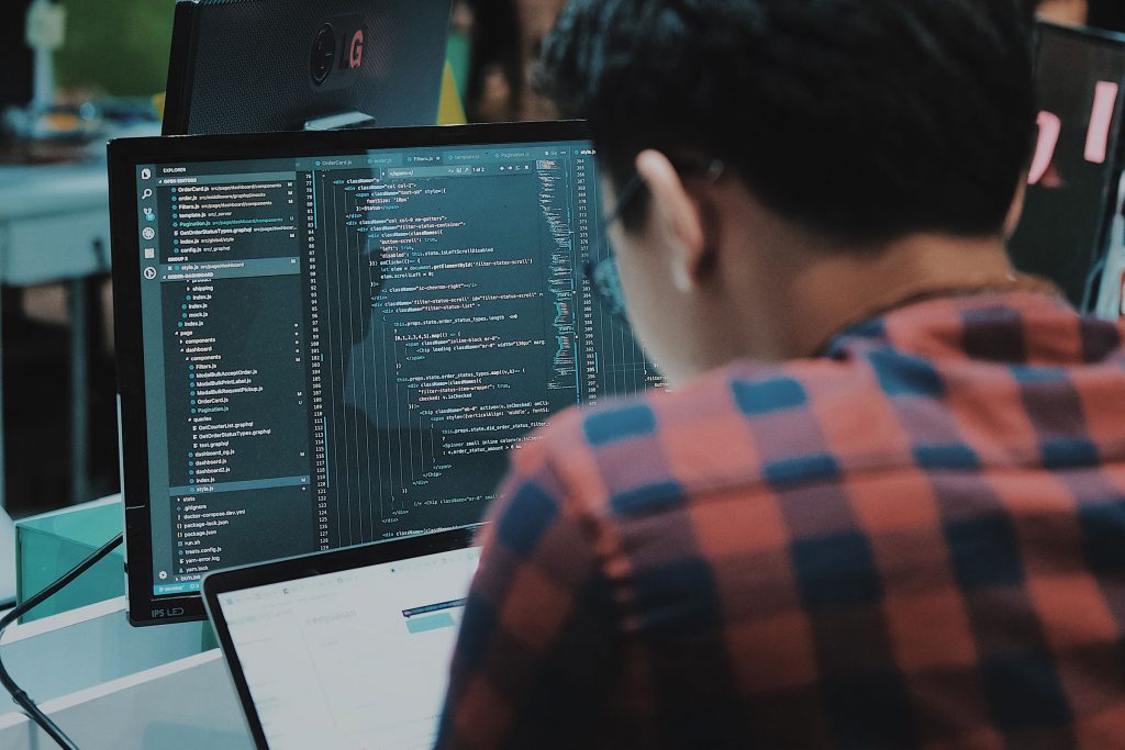 Computer scientist looking at data on a computer screen