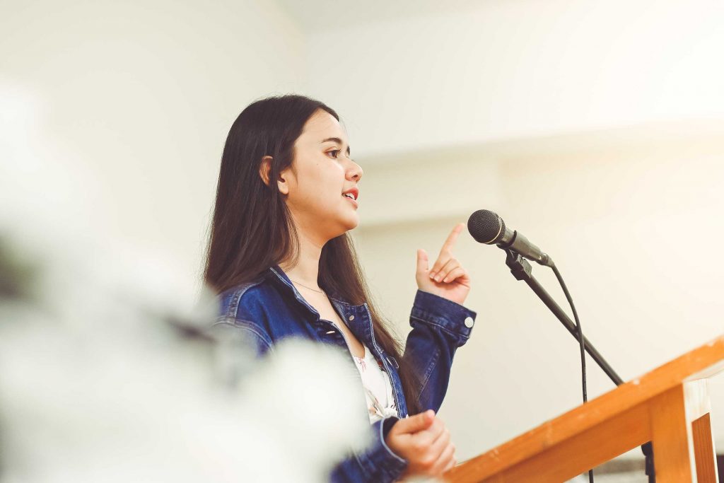 Female school student using her soft skills in public speaking