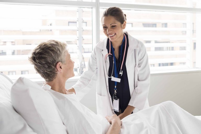 Female doctor talking with a patient in hospital