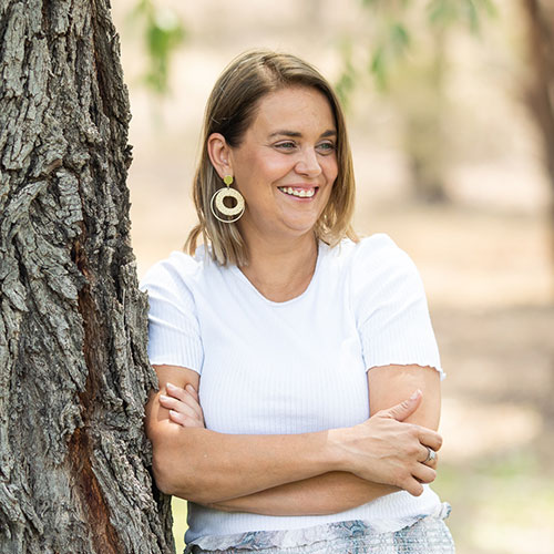 Leanne Sanders who founded a start-up, leaning against a tree