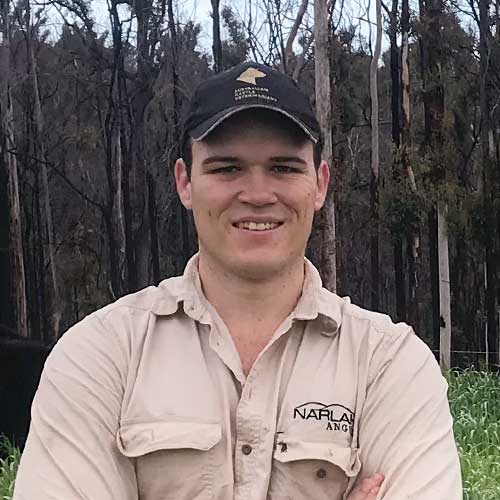 Liam Mowbray portrait infront of burnt bushland 