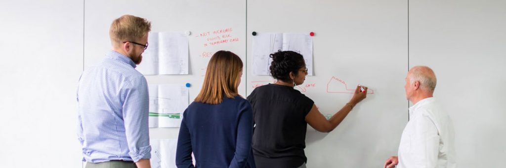 A group of people at a whiteboard plotting their civil engineering career