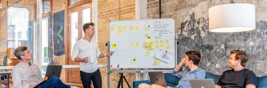 People sat around a whiteboard looking at civil engineering job requirements