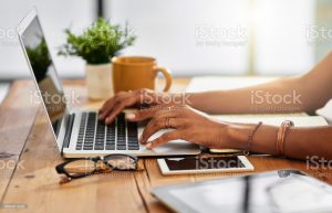 Shot of an unrecognizable woman working from home