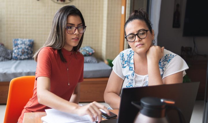 Mother and daughter in front of a laptop searching for types of sholarship