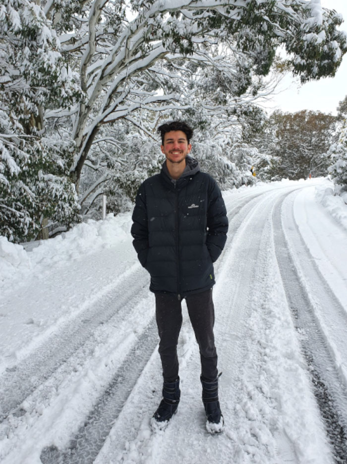 Photograph of Josh Lindsay standing on a road covered in snow.