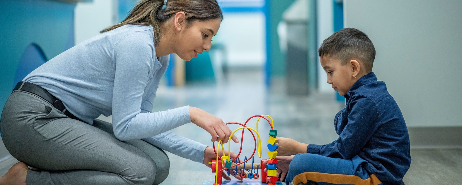 Female occupational therapist working with a child at play