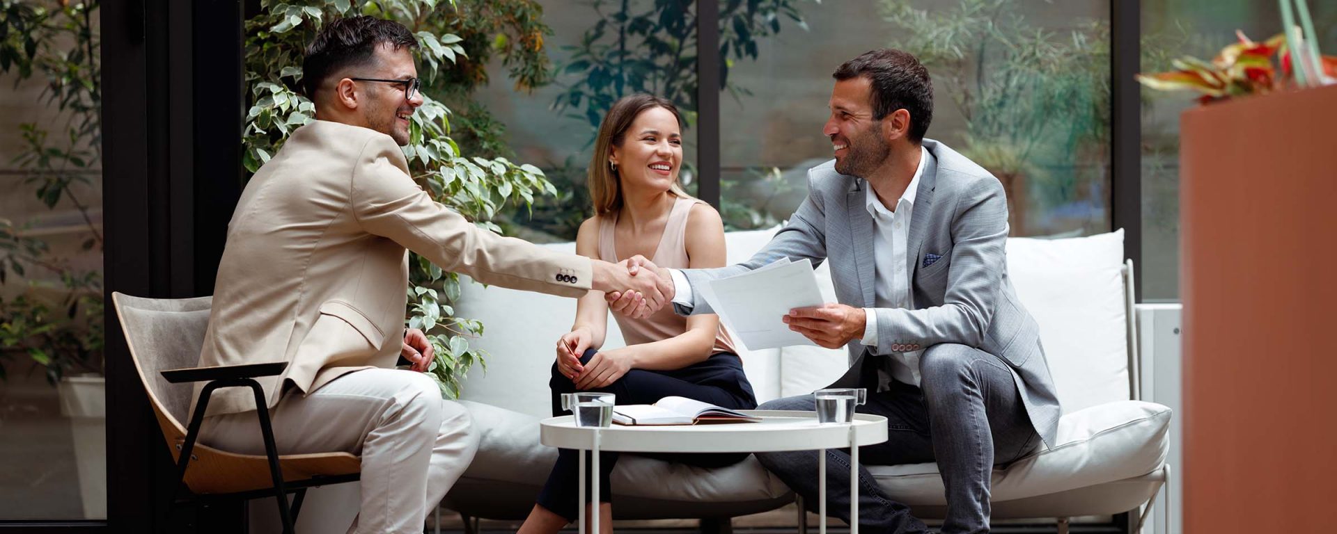 Woman and two men sitting around a table discussing the question what is ethical business