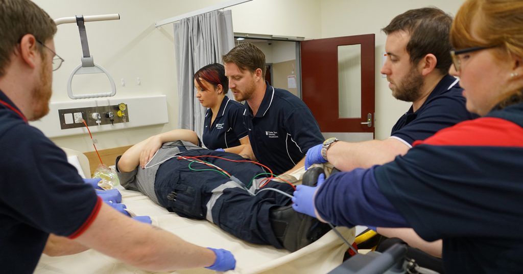 People working on a person on hospital bed