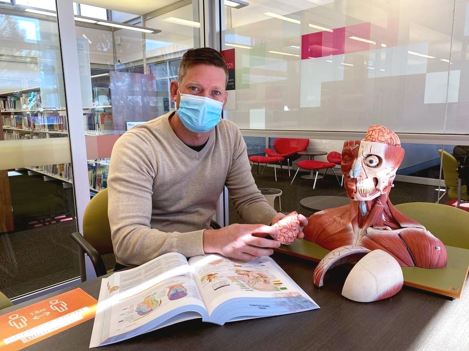 Student with an anatomical model studying rural medicine techniques