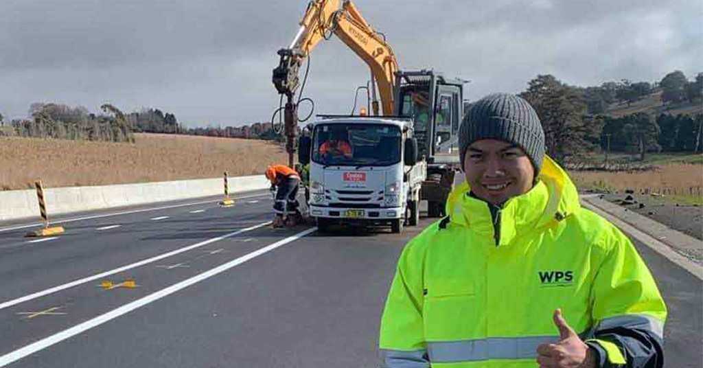 A Charles Sturt student who is pursuing civil engineering qualifications on site at a road construction