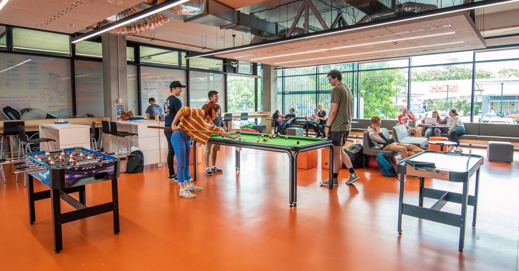 A group of uni students playing pool