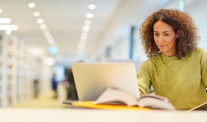 Mature aged student studying in the library.