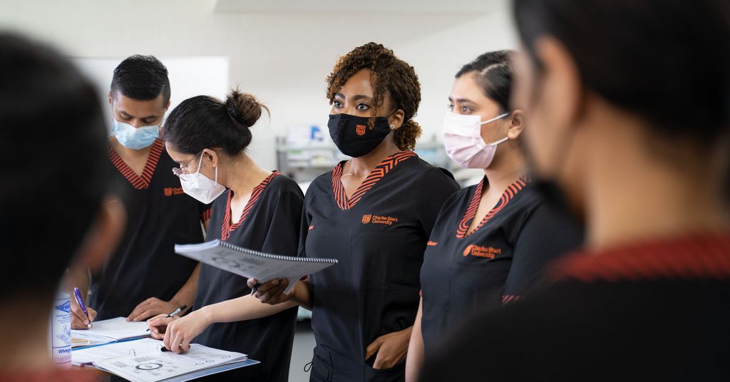 A team of ages care nurses in surgical masks