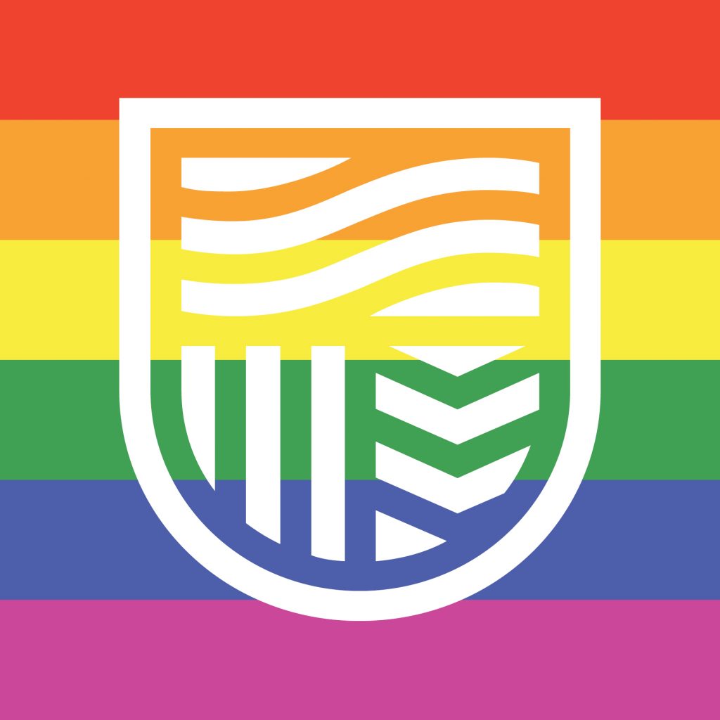 The Charles Sturt logo over a rainbow background