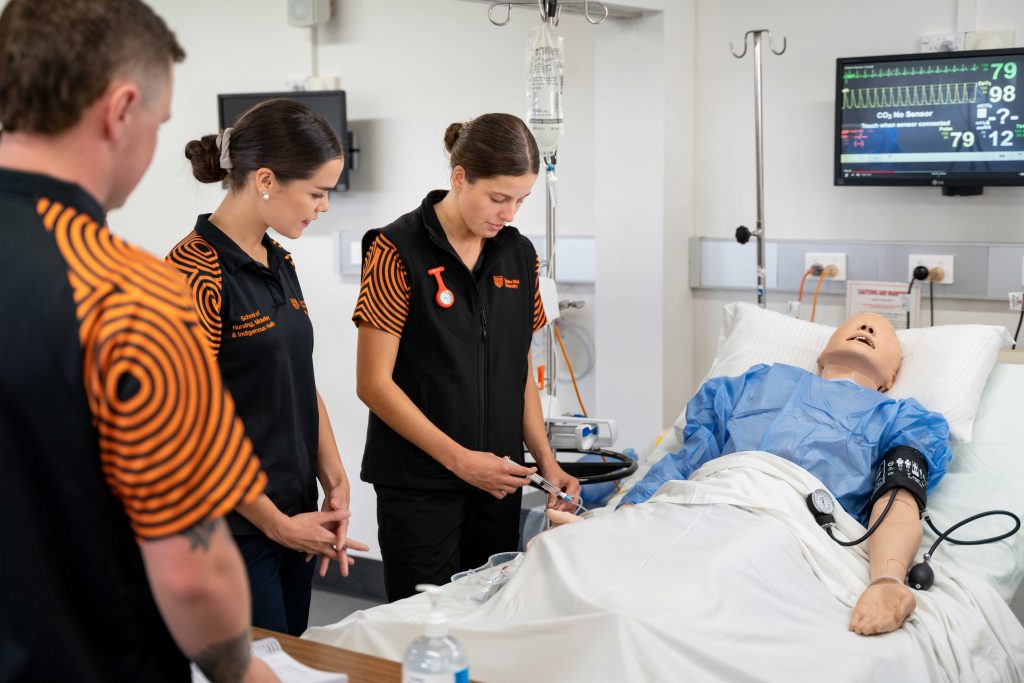 Student nurses with a dummy