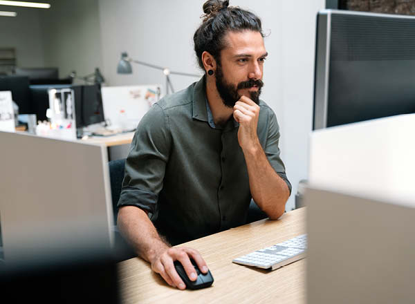 Video game developer working on a computer in an office