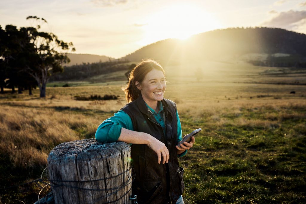 Woman with phone in agricultural field