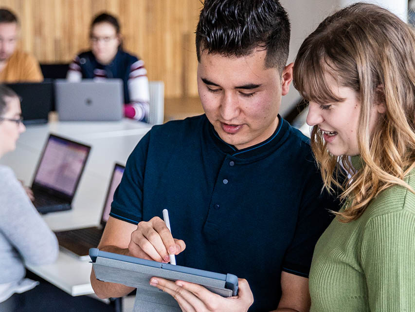 Woman and man looking at tablet