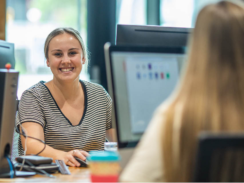 Two women working at computers