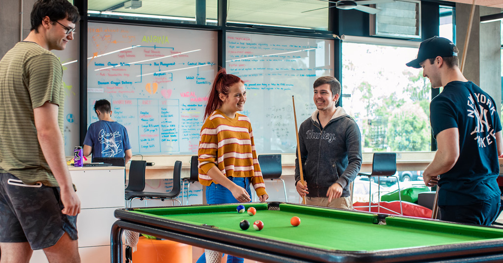 Group of students on campus playing pool