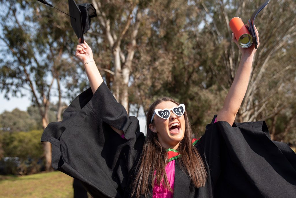 Woman in sunglasses celebrating finishing her degree faster