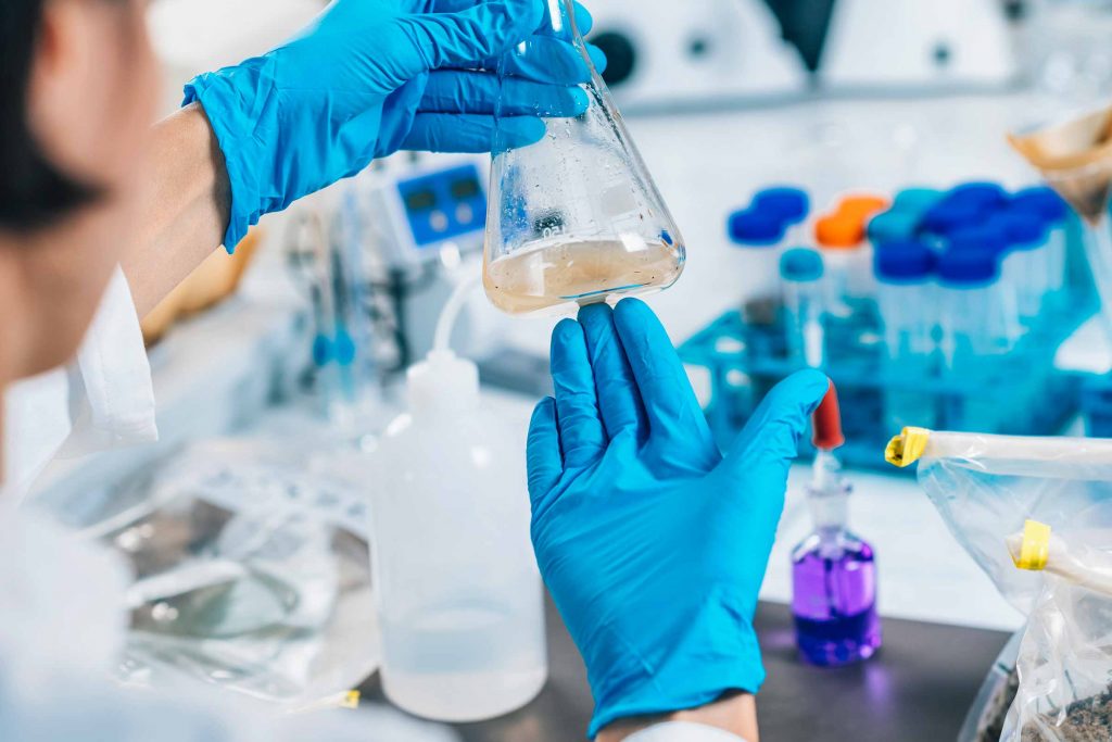 Microbiologist holding a beaker