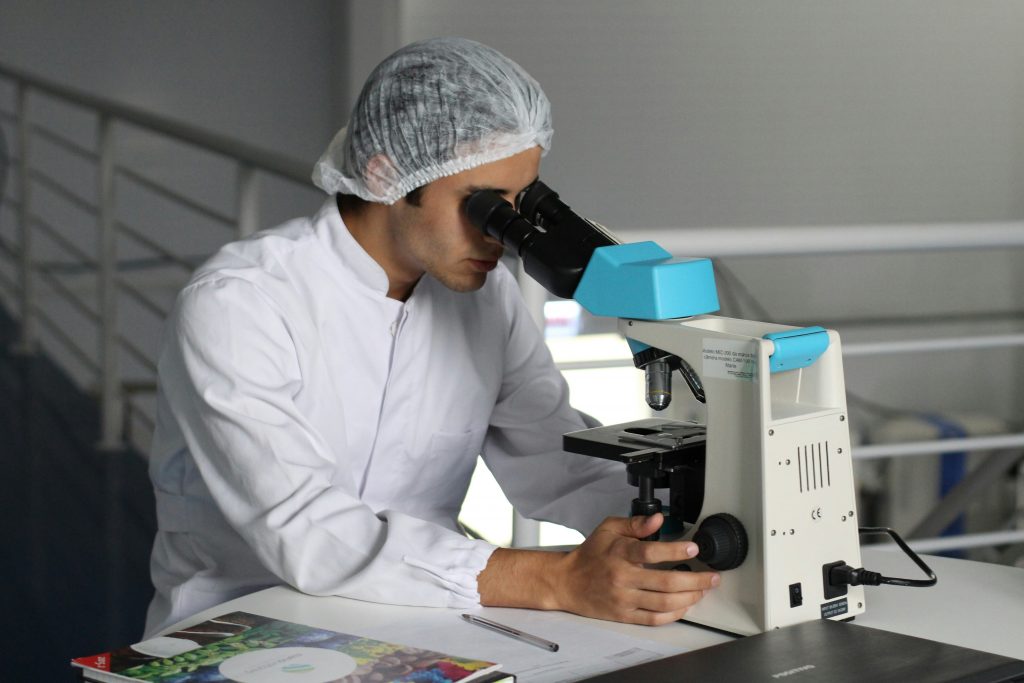 Man looking into microscope