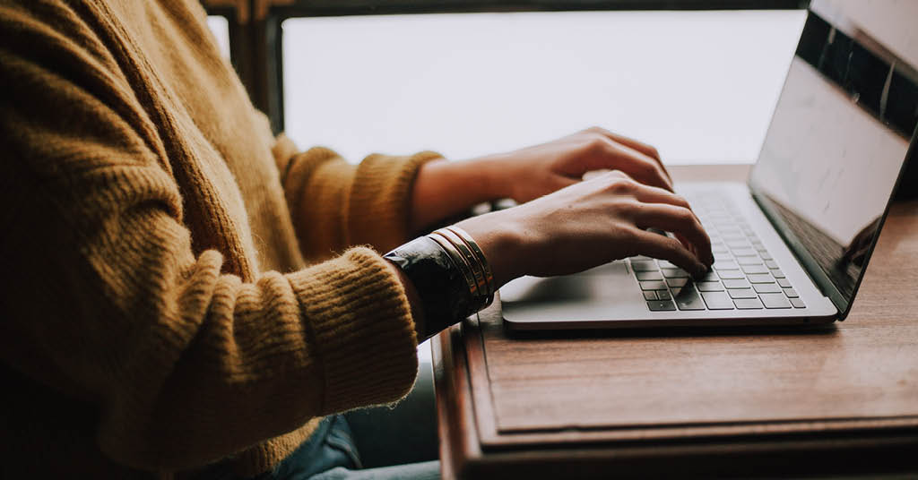 Close up of hands on a laptop