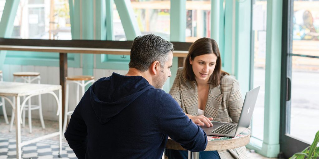 Two people discussing online finances.,