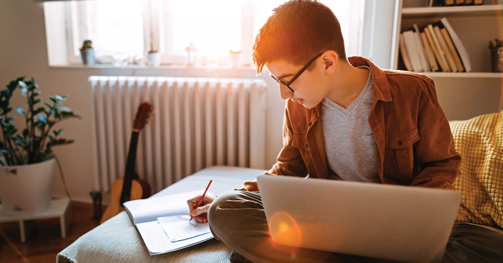 Males student taking study notes.