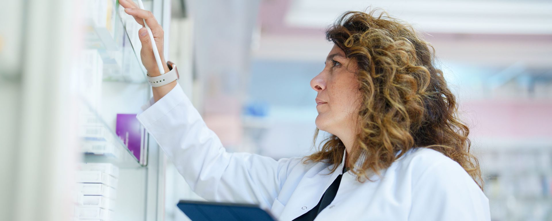 Pharmacist looking at medications in a pharmacy