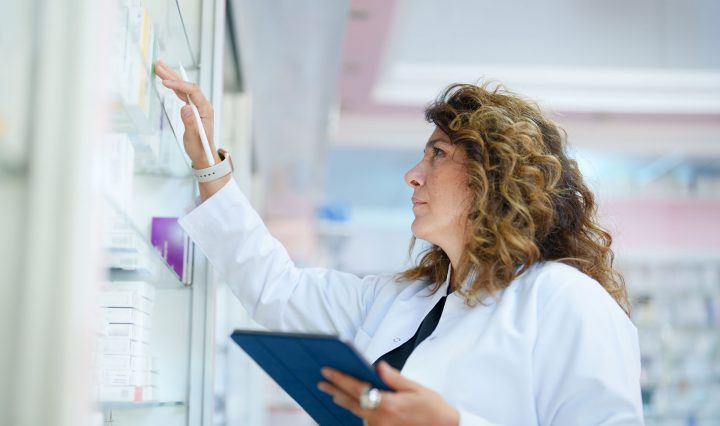 Pharmacist looking at medications in a pharmacy