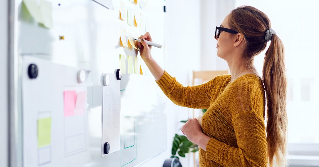 women writing on whiteboard