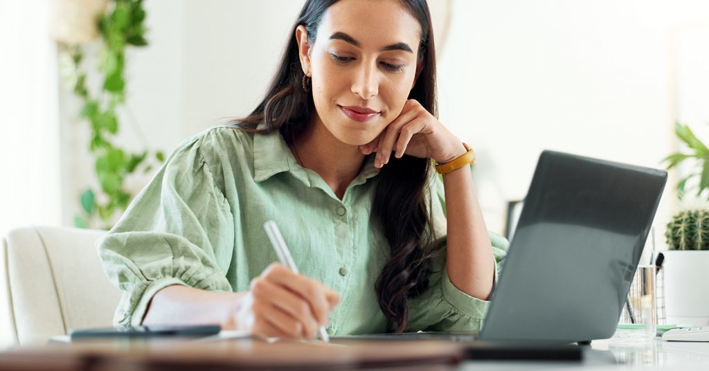 woman sitting at desk with laptop