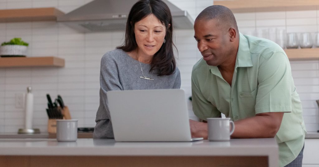 parents on laptop in kitchen