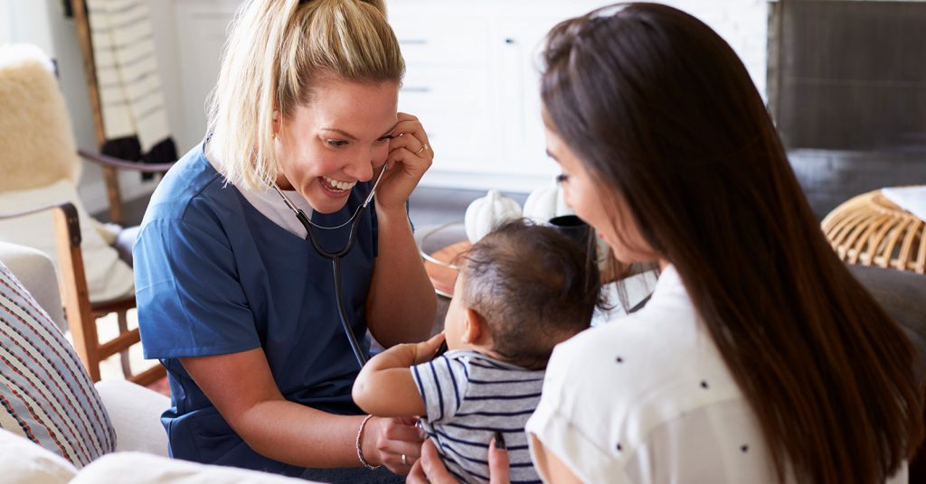 Allied health worker with woman and child.