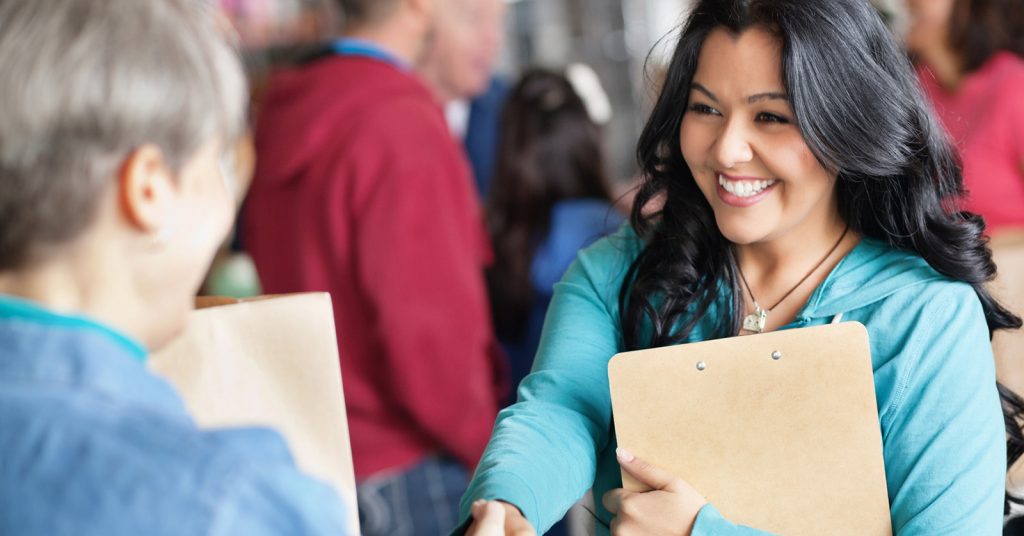 Woman shaking hands with clipboards
