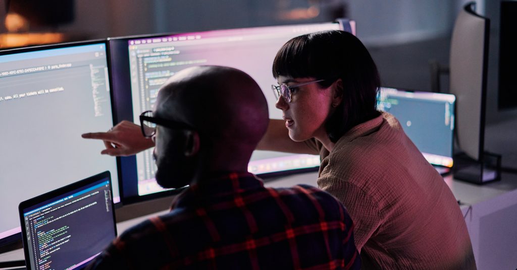 woman and man looking at computer screen