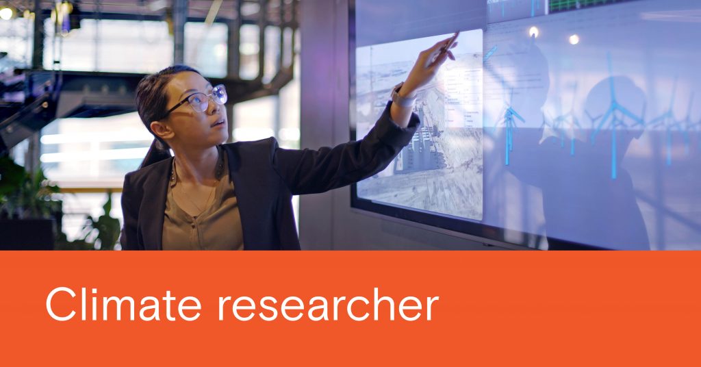 Orange banner down the bottom, white text that reads 'Climate researcher'. Image of a woman giving a presentation, pointing to screens about wind turbines and other renewables
