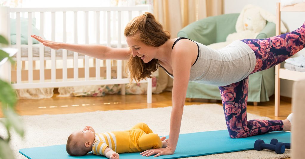mother and baby on yoga mat